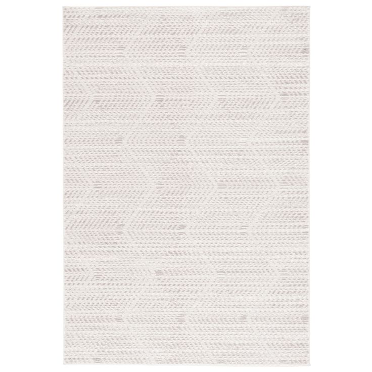 a white rug with an abstract design on the bottom, and a diagonal pattern at the top