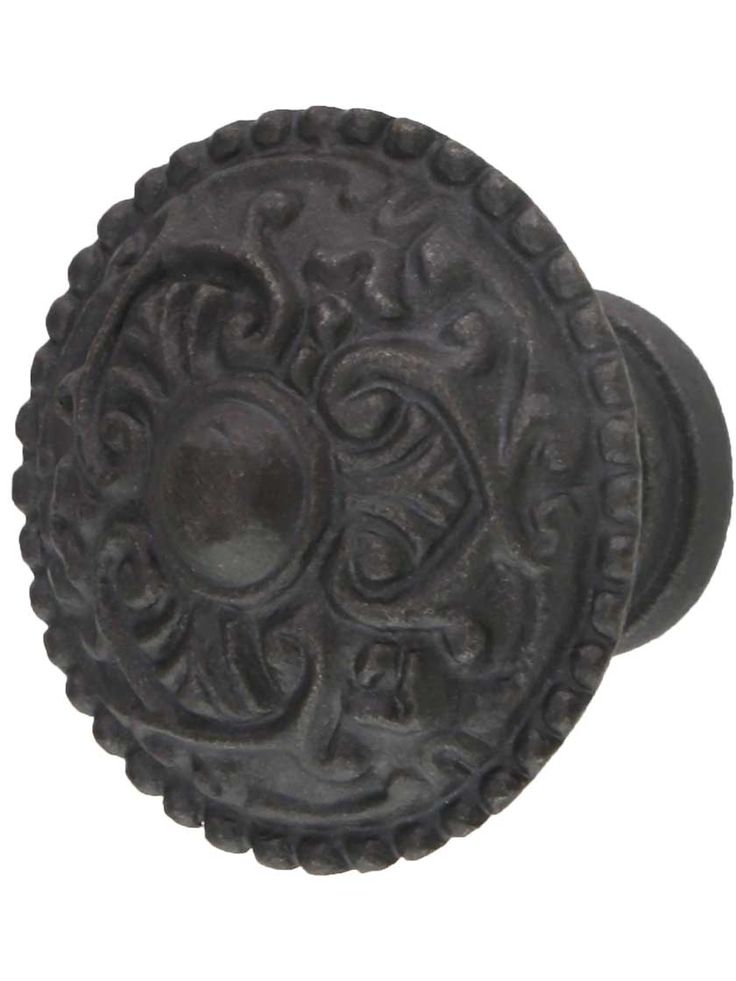 an old black door knob with ornate designs on it