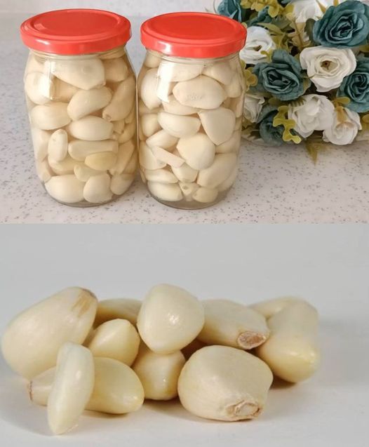 two jars filled with white beans next to flowers