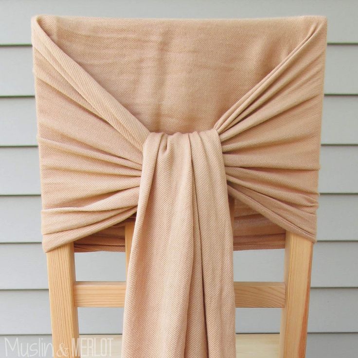 the back of a chair with a tan cloth draped over it