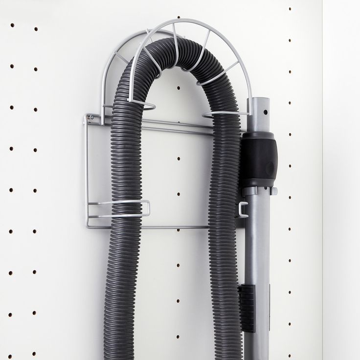 a wall mounted hair dryer with two hoses attached to it's side