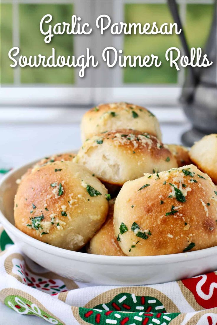 garlic parmesan sourdough dinner rolls in a white bowl on a table