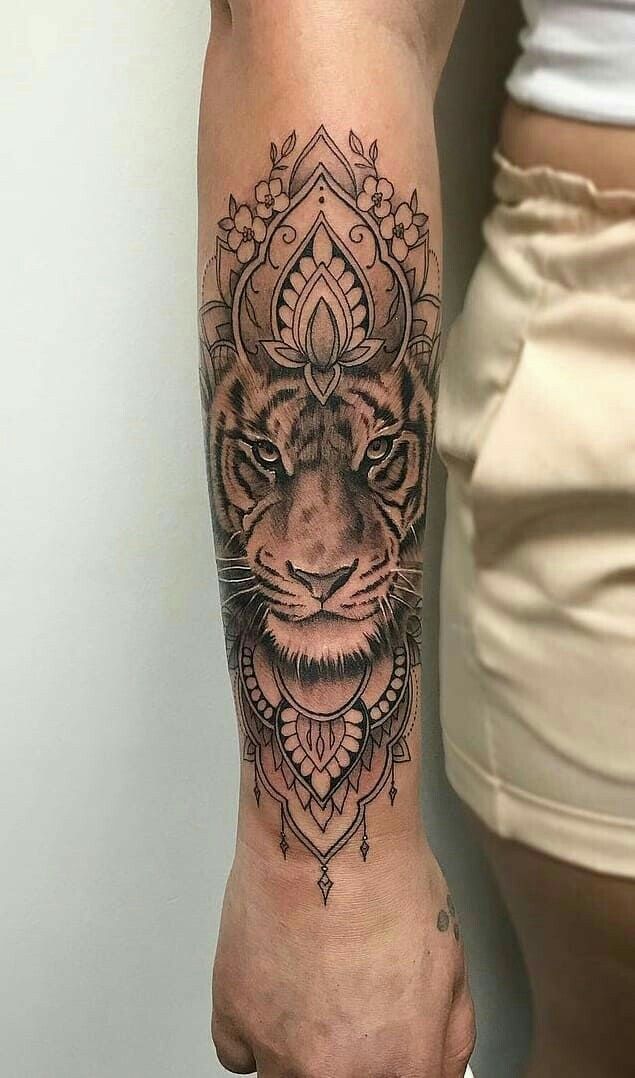 a tiger tattoo on the right arm and leg, with an ornamental pattern around it