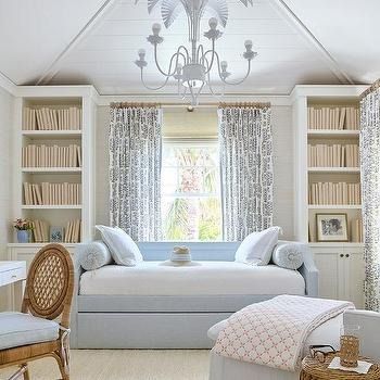 a bedroom with a bed, desk and chair in the corner next to bookshelves