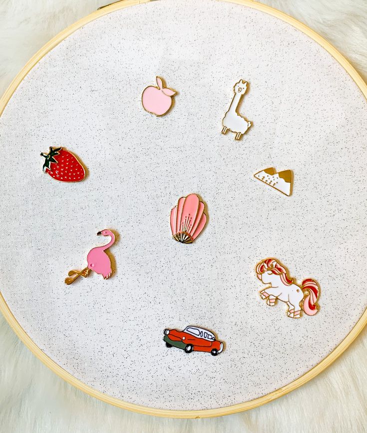 an embroidery project with various pins and magnets attached to the side of a hoop