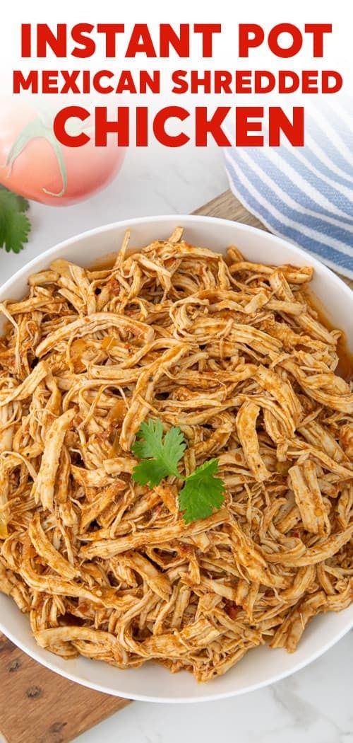 instant pot mexican shredded chicken in a white bowl with cilantro garnish