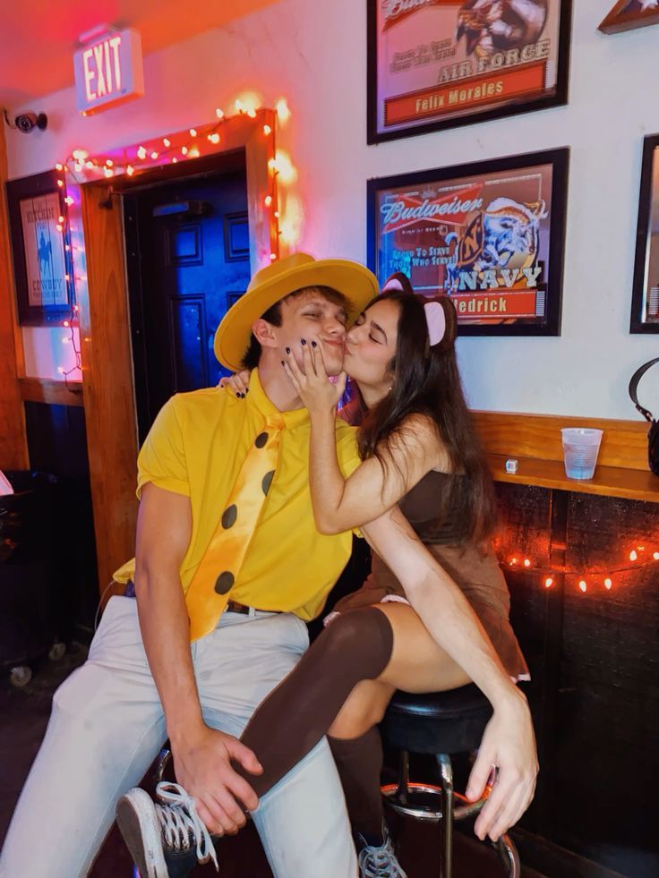 a man sitting next to a woman on top of a chair