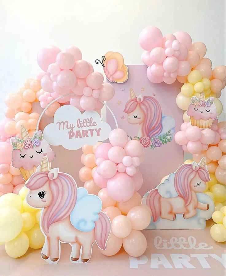 a unicorn themed birthday party with balloons and decorations