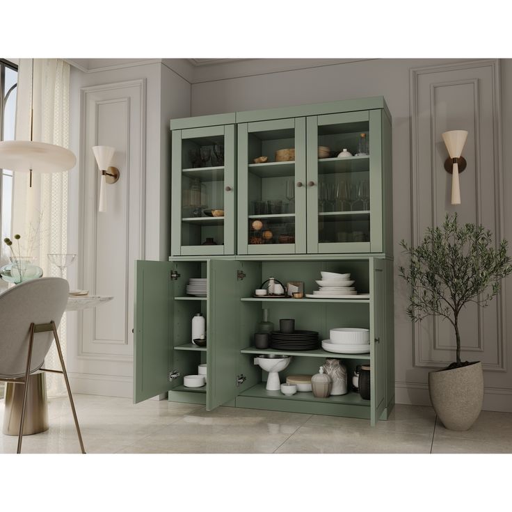 a green china cabinet with glass doors and shelves on the side, in front of a dining room table