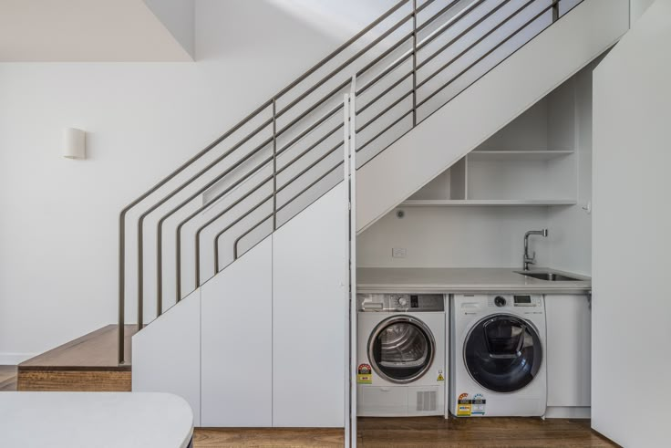 laundry under stairs laundry in the living, hidden laundry art deco stairs hardwood floor hidden laundry under stairs laundry cabinet white cabinet white laundry minimal laundry design small laundry integrated laundry sydney renovation Laundry Room Design Under Stairs, Laundry Under The Stairs, Washing Machine Under Stairs, Under Stair Laundry, Laundry Under Staircase, Under Stairs Utility, Under Stairs Laundry Room, Laundry Under Stairs, Under Stairs Laundry