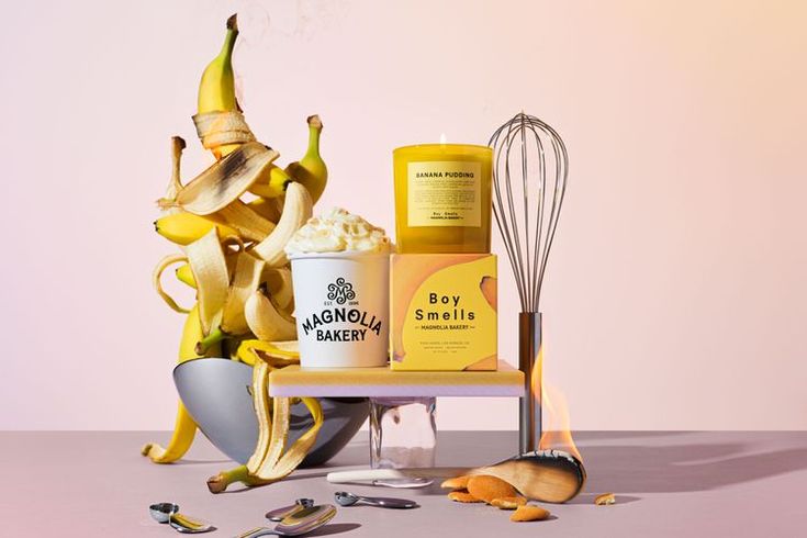 bananas and other ingredients on a table with a whisk next to it,