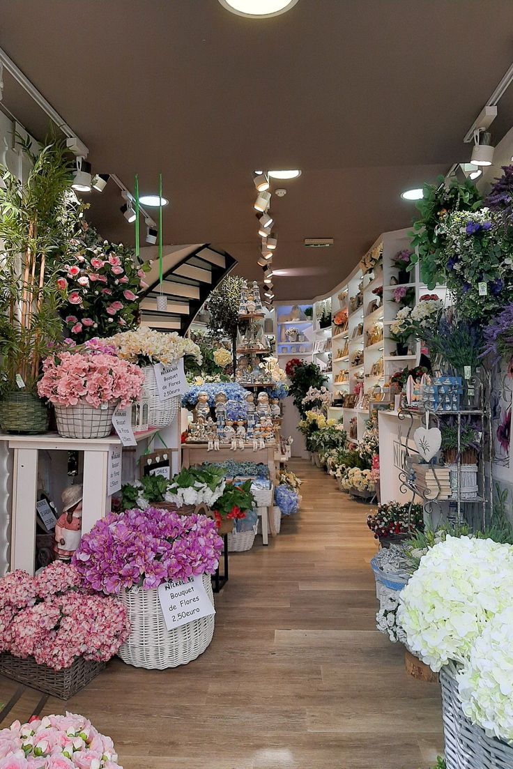 a flower shop filled with lots of different types of flowers