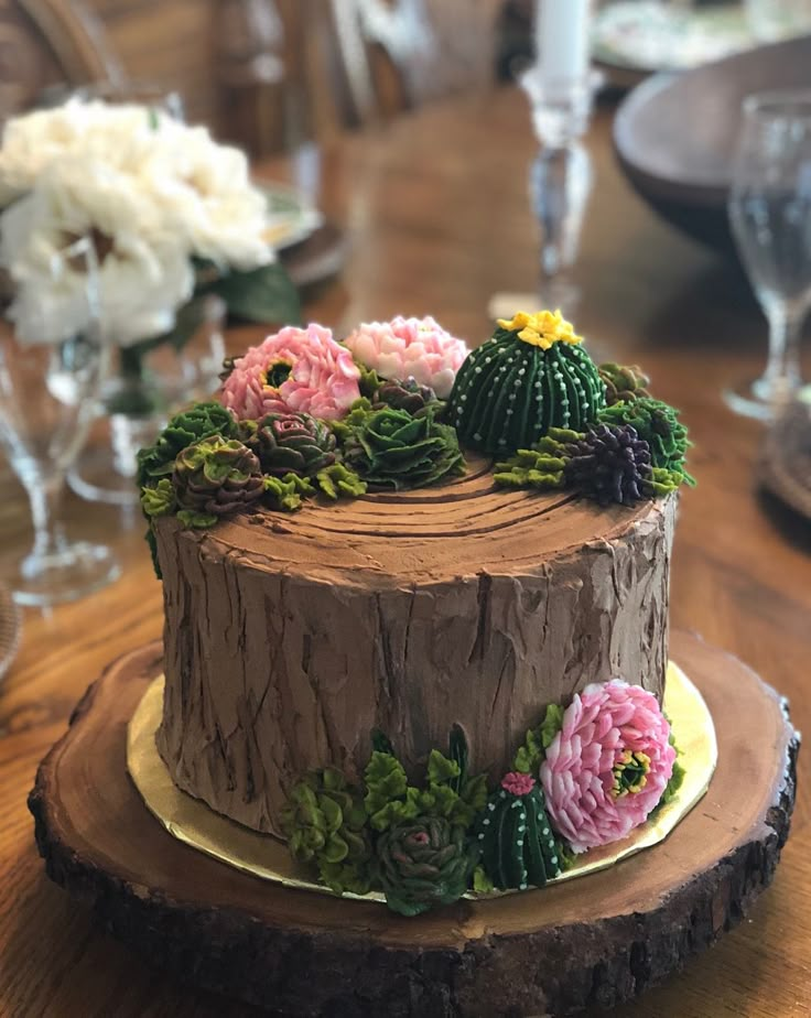 a cake decorated with flowers on top of a wooden table