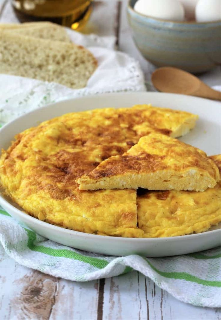 a close up of a plate of food with eggs in the background and text overlay that reads ricotta frittata oven baked