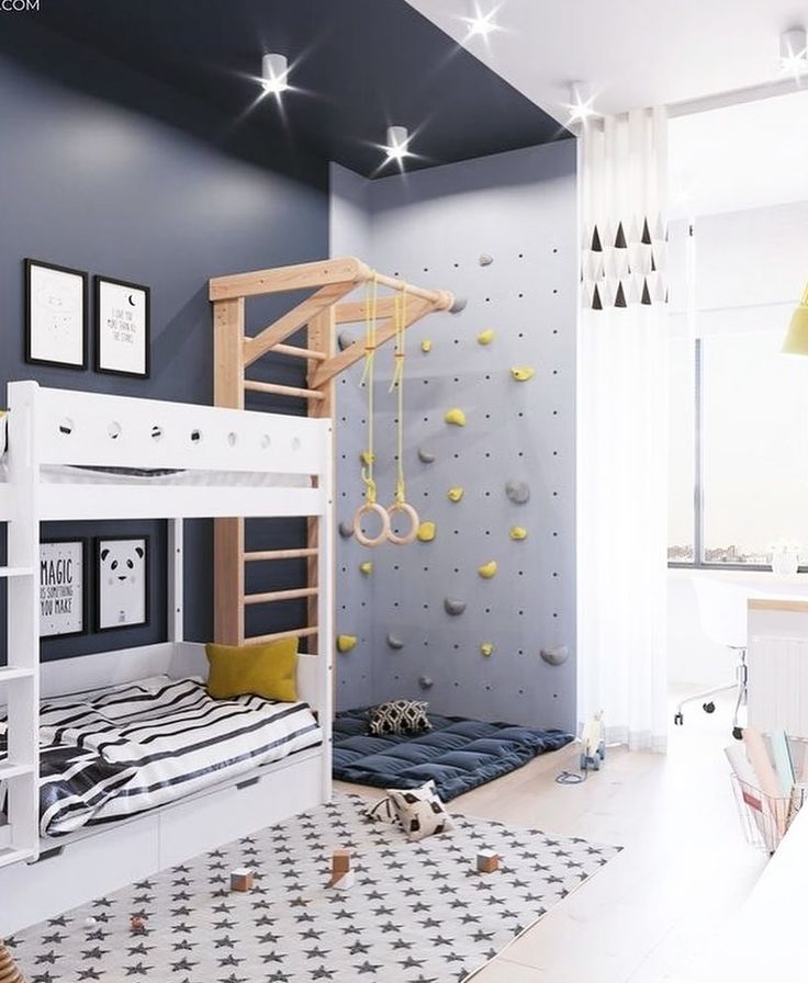 a child's bedroom with bunk beds and climbing wall