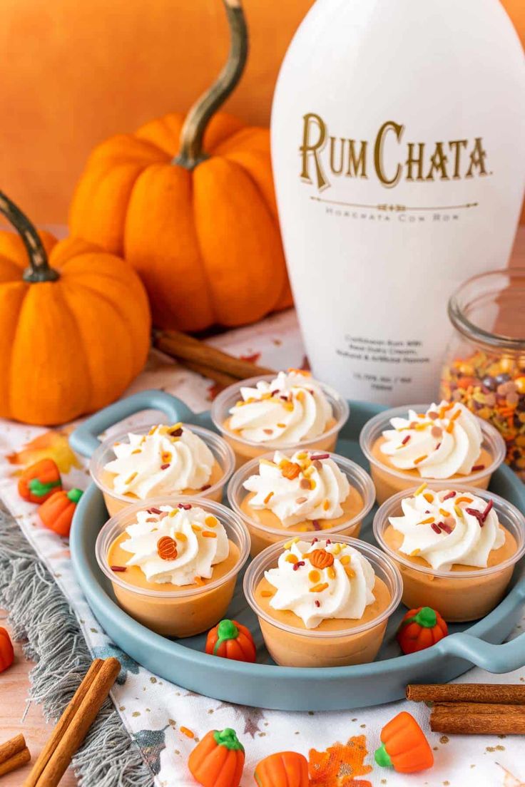 pumpkin spice cupcakes with rumchata frosting and candies on a tray