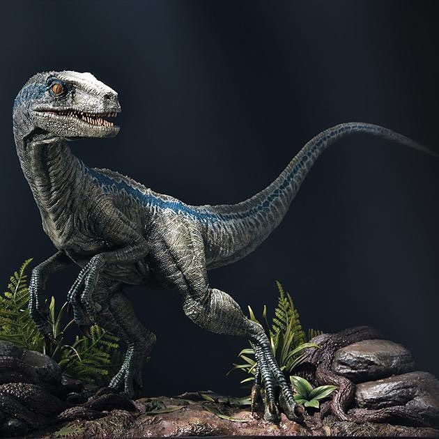 an image of a dinosaur that is walking in the grass and rocks with plants on it