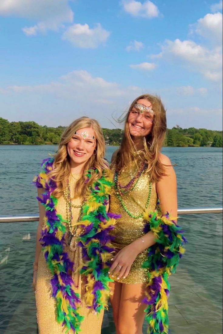 two beautiful women standing next to each other on a boat