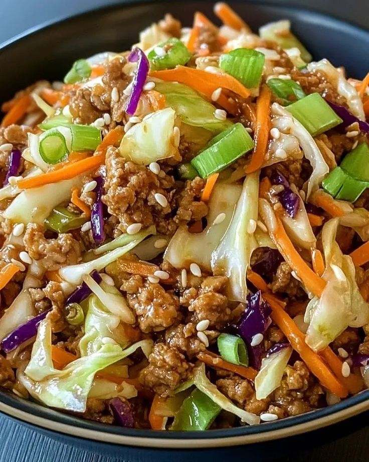 a bowl filled with meat and vegetables on top of a table