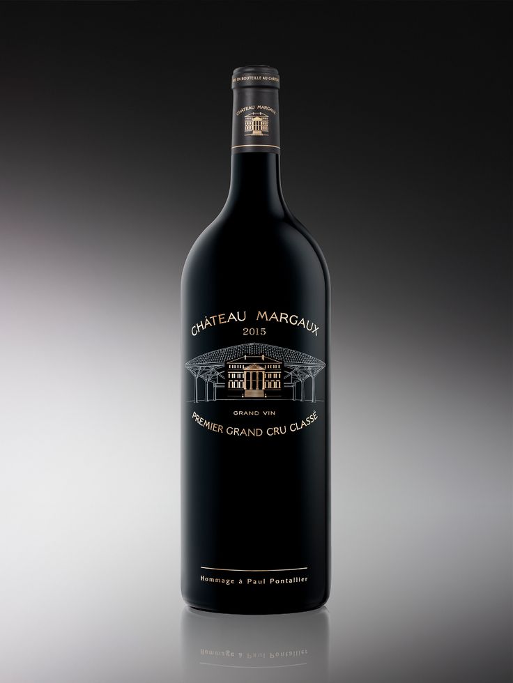 a bottle of wine is shown on a reflective surface in the dark room with its reflection