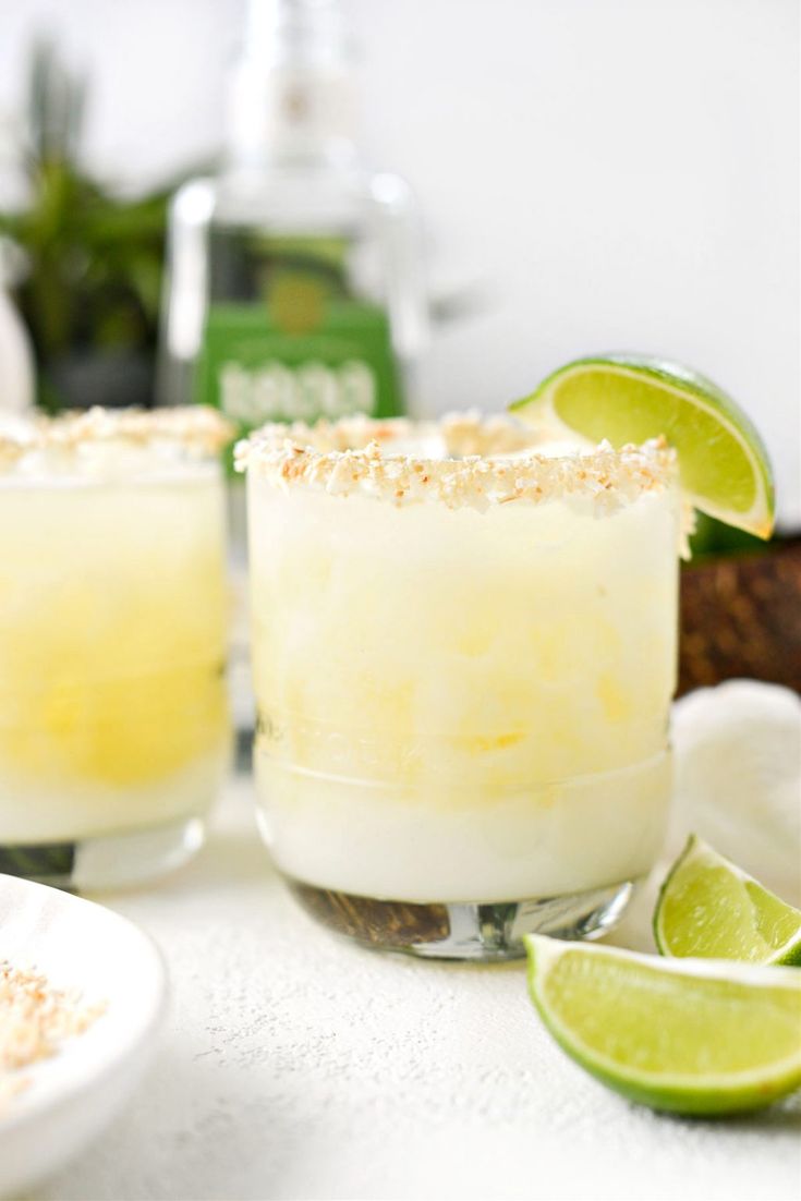 two margaritas sitting on top of a white table