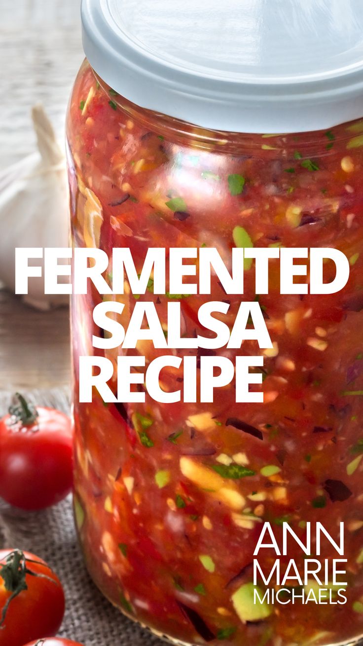 an image of fermented salsa recipe in a jar with tomatoes on the side