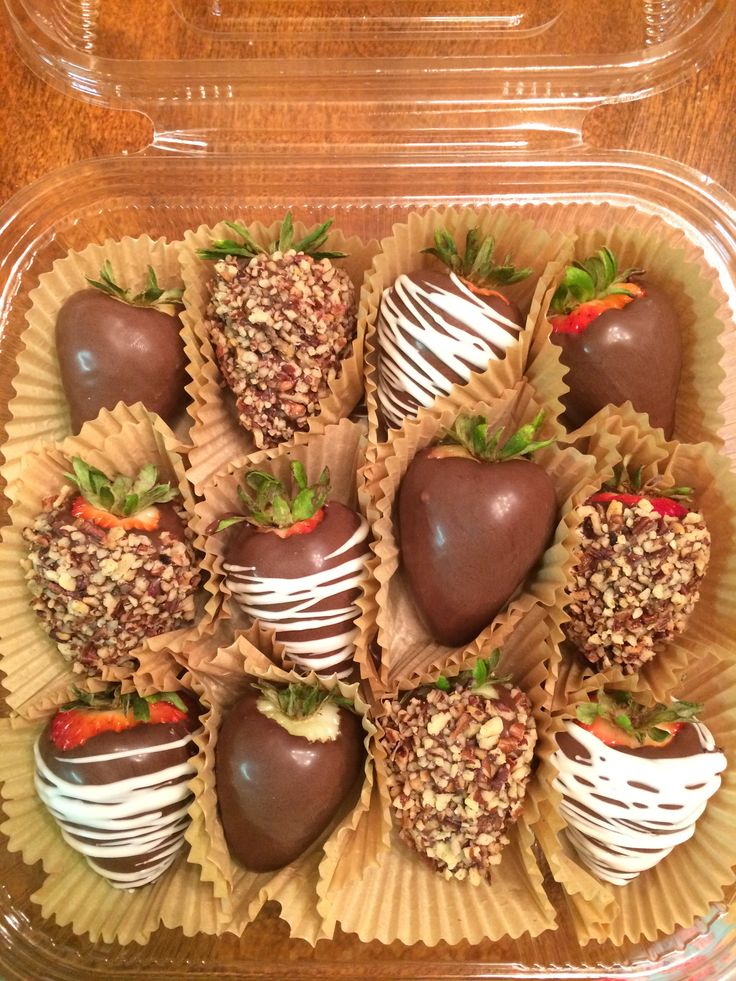 chocolate covered strawberries in a plastic container on a table