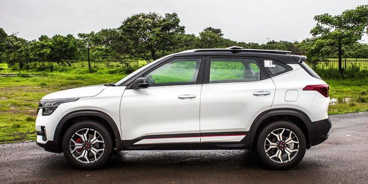 a white suv parked on the side of a road