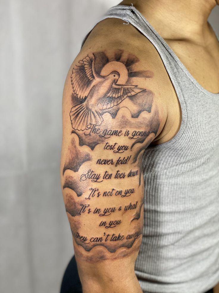 a man with a tattoo on his arm has a poem written in the clouds and a dove