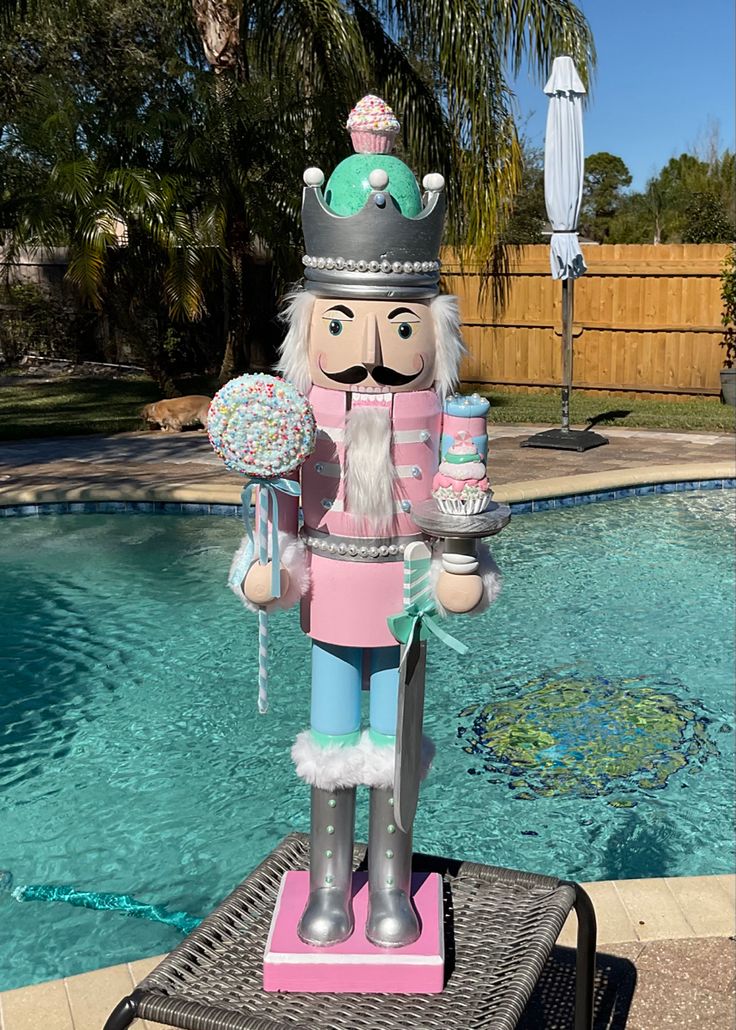 a large nutcracker statue sitting next to a swimming pool