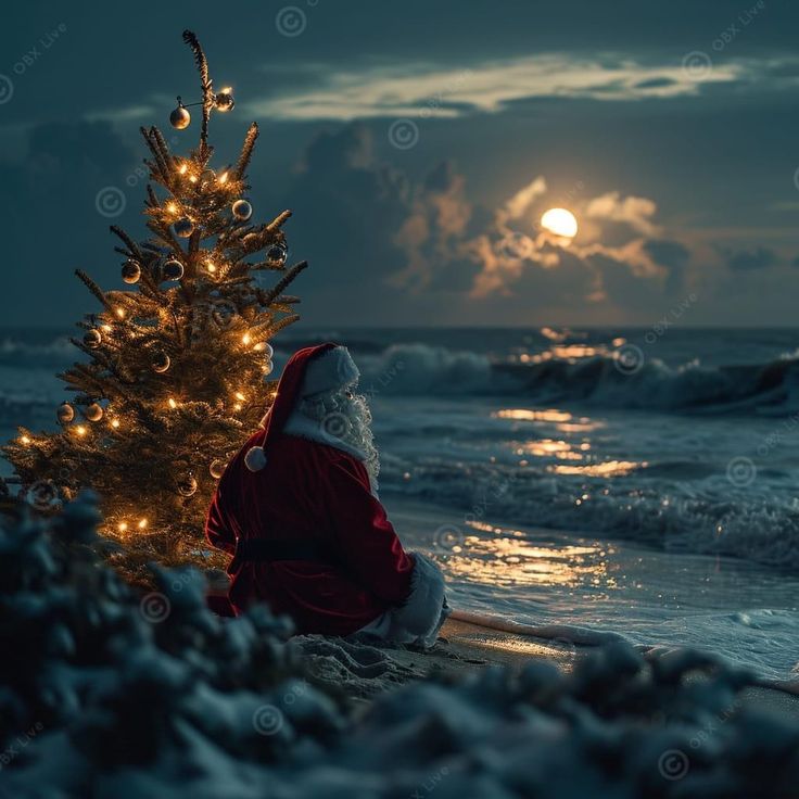 a santa claus sitting on the beach next to a christmas tree with lights in it