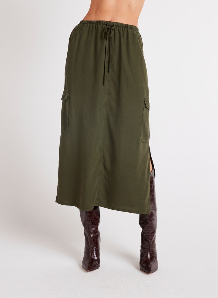 This Cargo Midi Skirt is a versatile addition to any wardrobe, featuring side slits for ease of movement and practical pockets for convenience. Made from soft Tencel fabric, this skirt is not only comfortable to wear but also stylish in beautiful colors. 100% TENCEL™Lyocell. Casual Knee-length Bottoms With Side Slits, Fall Utility Skirt With Side Pockets, Utility Skirt With Side Pockets For Fall, Relaxed Long Cargo Skirt For Work, Relaxed Fit Long Cargo Skirt For Work, Casual Midi-length Bottoms With Side Slits, Fall Midi Skirt With Side Pockets, Midi Bottoms With Pockets For Work, Midi Length Workwear Bottoms With Pockets