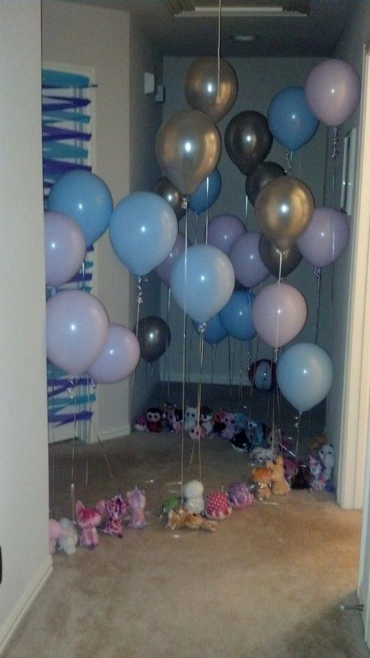 a room filled with balloons and stuffed animals