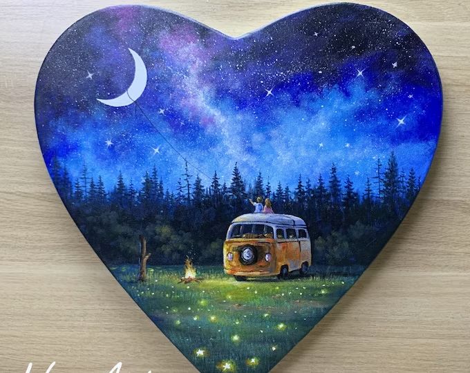 a painted heart shaped box with a camper van in the background and a night sky filled with stars