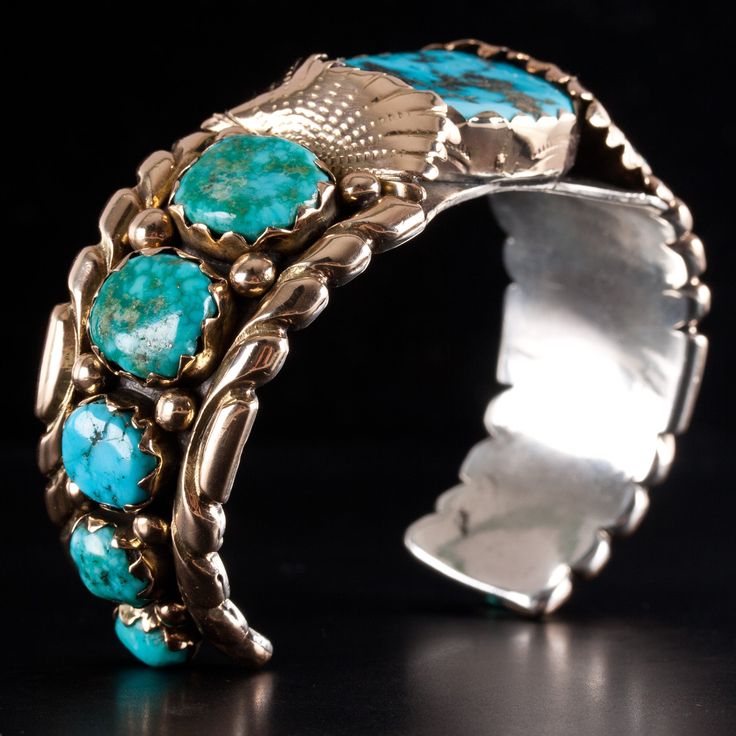 Vintage 14k Yellow Gold & Sterling Silver Zuni Morenci Turquoise Cuff BraceletMetal Information: 14k Yellow Gold & Sterling SilverTotal Weight: 86.2gBracelet Width: 27mmBracelet Length: 5.25"Bracelet Opening: 1.5"Circa: 1970'sCenter Stone: MorenciSide Stones: Sleeping BeautyStone InformationMain StoneGem Type: Morenci TurquoiseShape: Cabochon (25 x 20mm)Color: BlueClarity/Quality: ANumber of Stones: 1Accent StonesGem Type: Sleeping Beauty TurquoiseShape: Oval (13.8 x 12mm)Color: Blue / GreenClar Turquoise Cuff Bracelet With Polished Finish, Turquoise Bracelet Jewelry Collectible, Artisan Turquoise Jewelry With Polished Finish, Unique Turquoise Jewelry With Polished Finish, Unique Turquoise Bracelet Jewelry, Turquoise Jewelry With Oyster Bracelet As A Gift, Artisan Turquoise Jewelry For Formal Occasions, Elegant Turquoise Multi-stone Bracelets, Turquoise Bracelet With Polished Finish As Gift