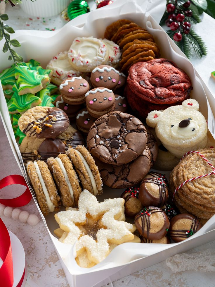 a box filled with lots of different types of cookies and pastries on top of a table