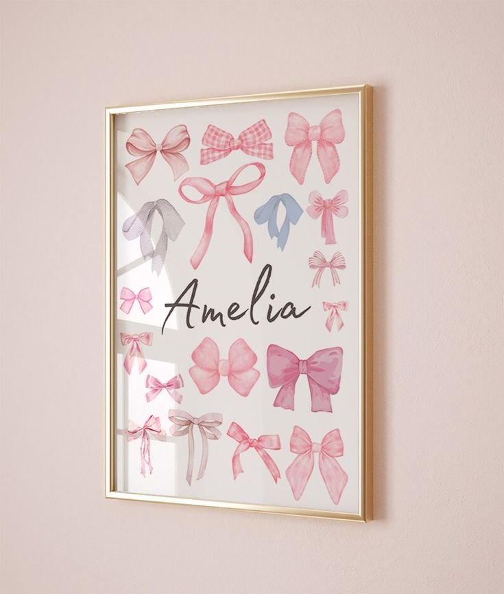 a pink and white framed wall with bows on it that says, amelia