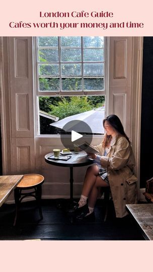 a woman sitting at a table in front of a window