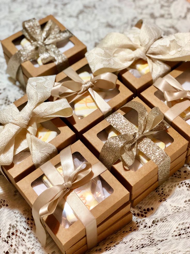 several small boxes with bows on them sitting on a table