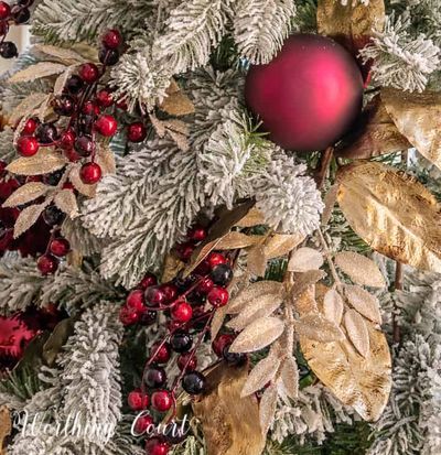 a close up of a christmas tree with ornaments on it