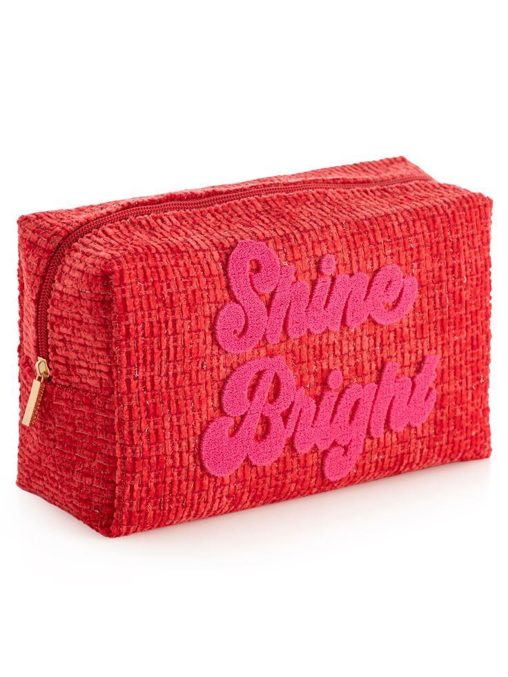 Carry all your odds and ends in shining style with Shiraleah's “Shine Bright” Zip Pouch! This compact cosmetic case is the perfect size to store makeup, jewelry, and anything else you might need to keep in one place this holiday season. Made from trendy tweed fabric in a vibrant red color with a subtle sparkle of lurex thread, the pouch features the words “Shine Bright” embroidered across the front in festive pink lettering. Pair with other items from Shiraleah's Merry Everything Collection to c Trendy Rectangular Cosmetic Bag As Gift, Trendy Rectangular Cosmetic Bag For Gift, Trendy Rectangular Cosmetic Bag Gift, Trendy Red Pouch With Zipper, Red Rectangular Cosmetic Bag Gift, Rectangular Red Cosmetic Bag As Gift, Rectangular Red Cosmetic Bag Gift, Trendy Red Pouch Cosmetic Bag, Red Cosmetic Bag With Zipper