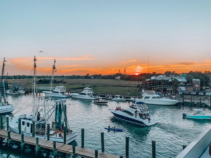 boats are docked in the harbor at sunset