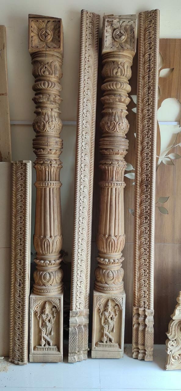 three carved wooden pillars sitting next to each other