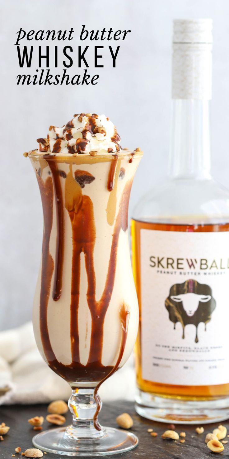 an ice cream sundae in a glass next to a bottle of whiskey and nuts