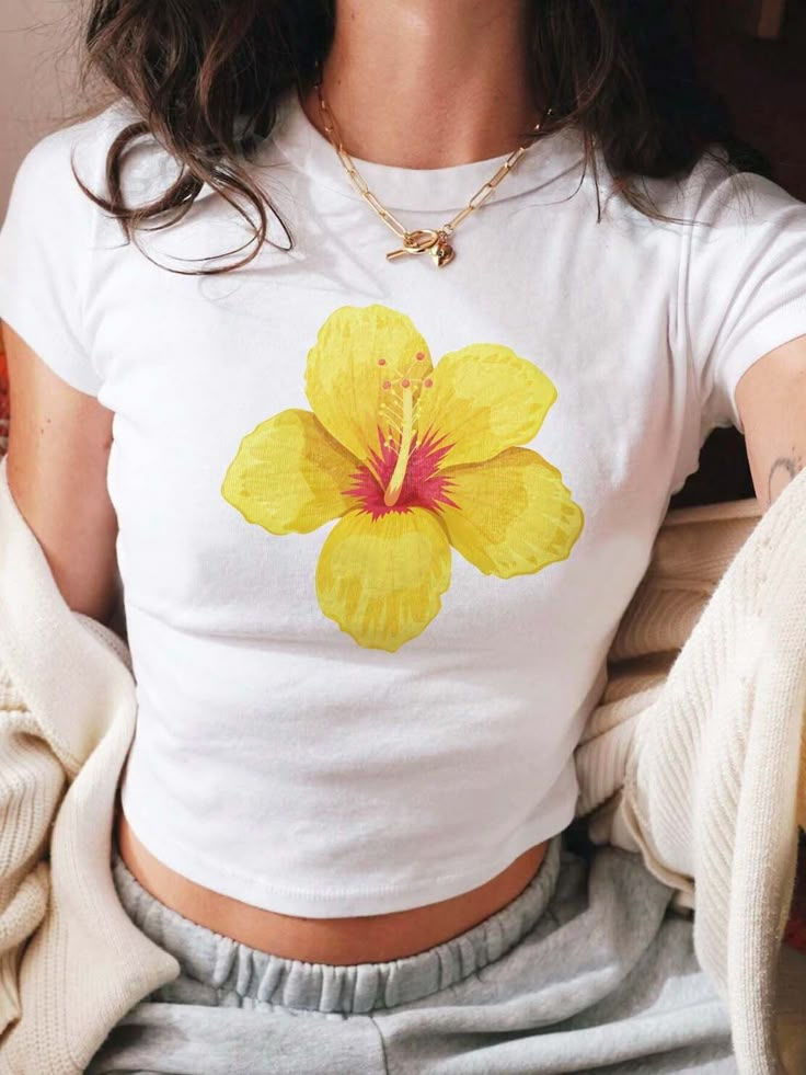 White Hibiscus Print T-shirt For Spring, White Cotton Hibiscus Print Shirt, White Cotton Shirt With Hibiscus Print, Casual Hibiscus Print Spring Top, Tropical Crew Neck Tops For Spring, White Tropical Floral Print Top, White Tropical Top With Floral Print, White Hibiscus Print Summer T-shirt, White Hibiscus Print T-shirt For Summer