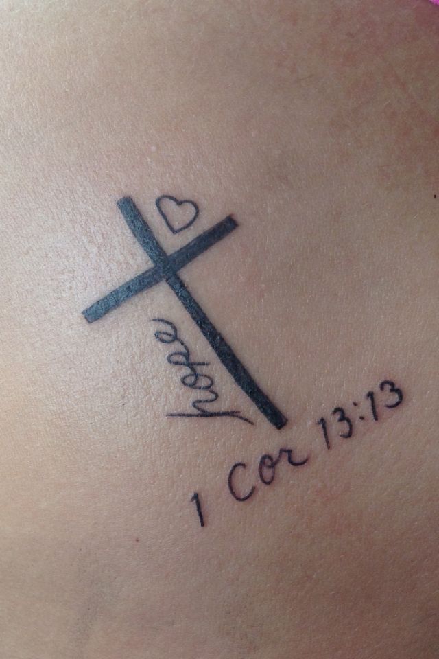 a cross with the words i love you and a heart on it is shown in black ink