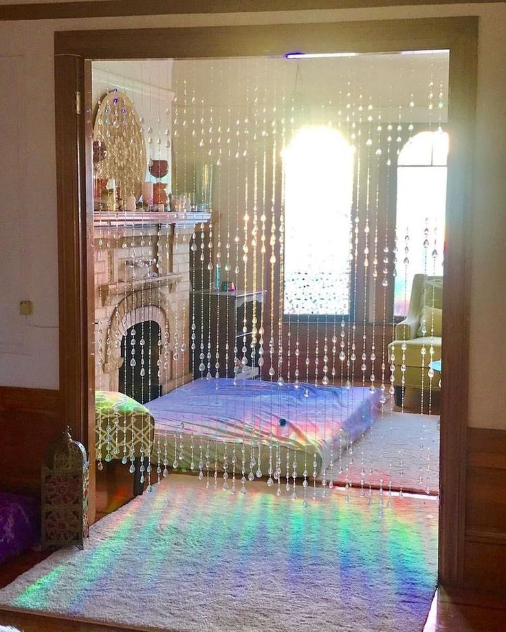 a bedroom with a bed and a fireplace in the corner that has rainbow lights on it