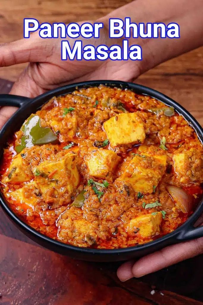 paneer bhuna masala in a black bowl on a wooden table with text overlay