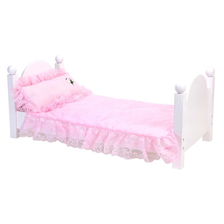 a white doll bed with pink ruffled bedspread