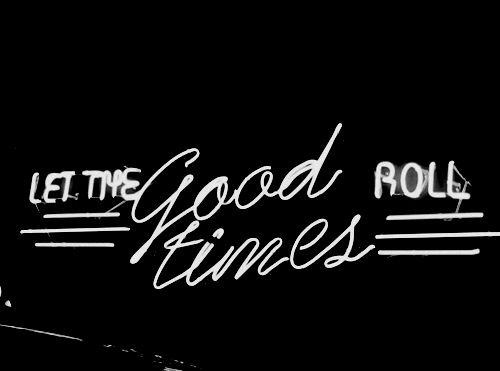 the words let the good times roll in white on a black background